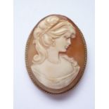 A vintage 9ct gold and carved shell cameo brooch, depicting the profile of a young lady with upswept