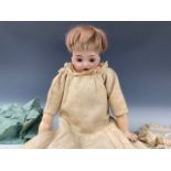 A Victorian bisque-headed doll, of diminutive size, having sleeping eyes and an open mouth, shape No