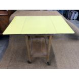 A 1960s buttercup yellow formica tea trolley