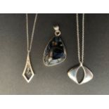 Three contemporary silver / white metal (tests as silver) and hardstone pendant necklaces, 33.5g