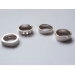 Four contemporary silver / white metal (tests as silver) rings of a geometric design, 27.6g