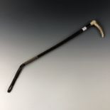 A horn handled and leather riding crop