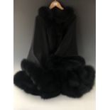 A lady's black wool hooded evening cloak with fox fur trim