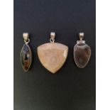 Three contemporary silver / white metal (tests as silver) and polished stone pendants, including a