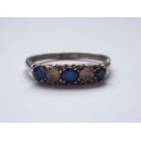 A vintage silver and paste five-stone dress ring, with alternating blue and white stones, pellet-set