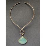 A contemporary silver and green stone torque necklace, pendant approximately 4.5 x 4 cm, 50.9g