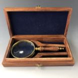 A cased brass magnifying glass