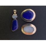 Contemporary silver and gemstone pendants, including a polished blue-agate pendant, and a lapis