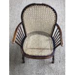 An Arts & Crafts period caned Windsor armchair