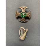A silver and Connemara marbled Celtic harp brooch, together with a cruciform brooch centred by a
