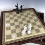 A bisque porcelain chess set, the pieces modelled as Classical gods