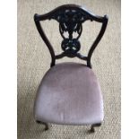 A late 19th century carved mahogany salon chair