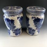 A pair of ceramic blue and white stools, decorated with a grape design