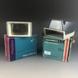 A boxed Hanimex Hanorama 2 x 2" slide viewer and one other viewer