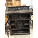 A late Victorian Flemish style carved oak bookcase / cabinet, 107 x 31 x 132 cm