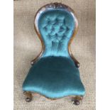A Victorian mahogany spoon back chair, with cabriole legs and ceramic casters