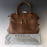 A Modalu Pippa Crossbody brown leather handbag, together with Modalu cotton bag protector