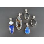 Four contemporary white metal (test as silver) and hardstone pendants, including a lapis lazuli