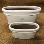 Two RHS white glazed oval flower troughs retailed by Waitrose, 56 cm diameter and 31 cm diameter