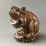 A Japanese carved wood netsuke modelled as a rat