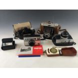 Vintage cameras including an AGFA Jsolette, an Olympus Trip 35 with instruction booklet, a Kodak "