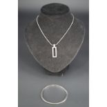 A contemporary Beaverbrook modernist silver pendant necklace and bangle in original packaging