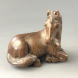 A Japanese carved wood netsuke modelled as a pony