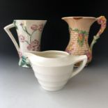 Mid-Century ceramics comprising Maling and Arthur Wood flower jugs and a Wedgwood Keith Murray