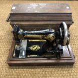 A vintage cased Singer hand sewing machine