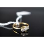 An 18ct gold platinum and three-stone diamond ring, illusion and twist-set, O, 2.2g (a/f)