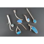 Contemporary white metal (tests as silver) and blue stone pendants, of curvilinear design, 27.8g