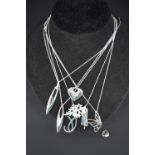 Contemporary white metal (tests as silver) pendant necklaces, including a stylized butterfly and a