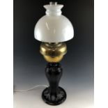 A composite oil lamp on cast brass base, converted to electricity