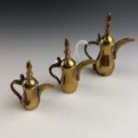 Three miniature brass dallahs / Arabic coffee pots, largest 8 cm