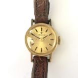 A lady's 9ct gold cased Tissot wrist watch, with gilt circular dial and baton markers, 10.8g total