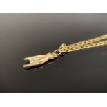 A 9ct gold flat curb link neck chain with a high carat yellow-metal pendant (tests as gold) in the