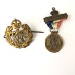 A Second World War RAF cap badge together with a 1937 Coronation medallion