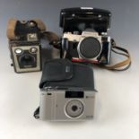 An early 1970s Praktika LB camera, a Brownie Six-20 Model C and a Ricoh FZ-70