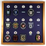 A framed display of post-War German Police / Deutsche Polizei badges
