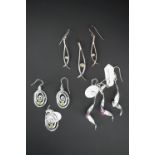 Three contemporary white metal (tests as silver) pendant necklace and earring sets, each of a