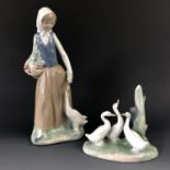 Two Nao porcelain figurines comprising a young woman with geese, and a geese group