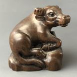 A Japanese carved wood netsuke modelled as water buffalo