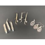 Three contemporary white metal (tests as silver) pendant necklace and earring sets, each of a