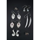 Contemporary white metal (tests as silver) earrings, including a pair of curled leaf ear pendants,