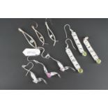 Three contemporary white metal (tests as silver) pendant necklace and earring sets, each of a