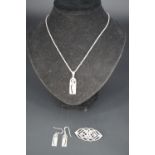 A Charles Rennie Mackintosh style white metal (tests as silver) pendant necklace and earrings,