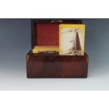 A Victorian rosewood tea caddy containing a quantity of stereograph views of America and Britain,