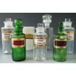 Five 19th Century glass pharmacy / chemist jars, in green and clear glass, each with gilt-bordered