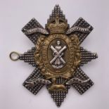 A Black Watch officer's white metal (tested as silver) and gilt metal cap badge