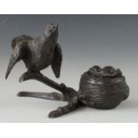 A Victorian novelty inkwell modelled in the form of a bird and nest on a gnarled bough, the next